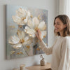 Žena posmatra sliku Cvjetni svijet na platnu Užitak za vaša osjetila 60x60 cm na zidu u stilskom svijetlom enterijeru | Papilora (XOBMDFL022E1)